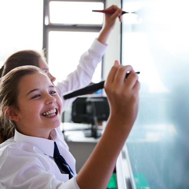 Students writing on the board in class